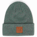 Green beanie with a brown leather patch on a white background