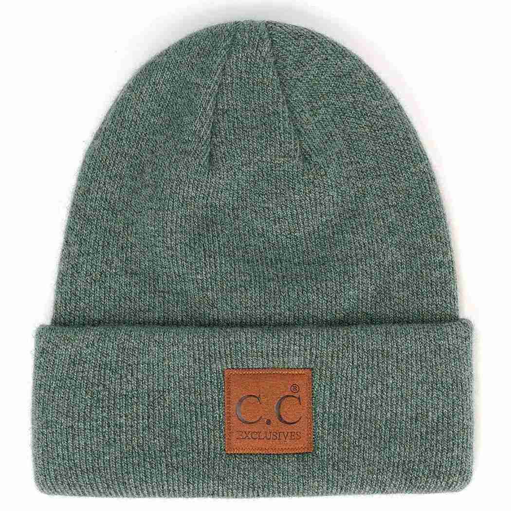 Green beanie with a brown leather patch on a white background