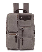 Gray canvas backpack with multiple zippered pockets and leather accents