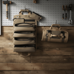 Two tactical bags on a wooden surface with tools in the background